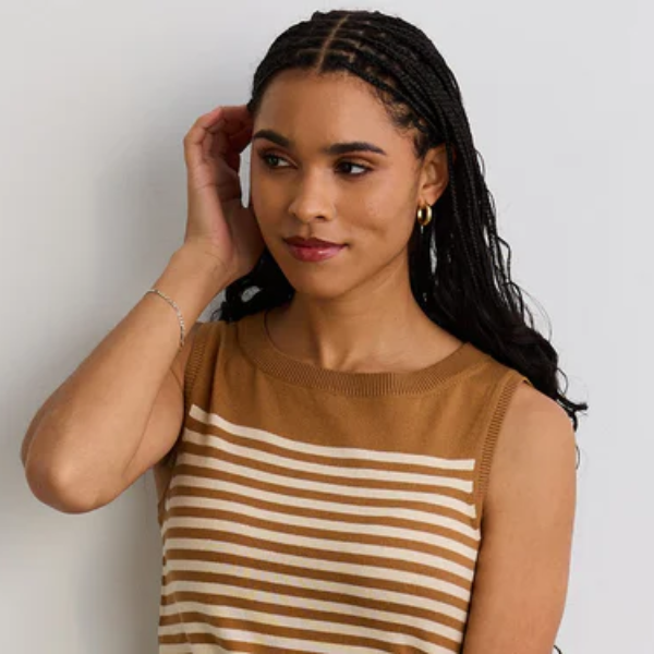 Woman wearing a striped dress against a plain background